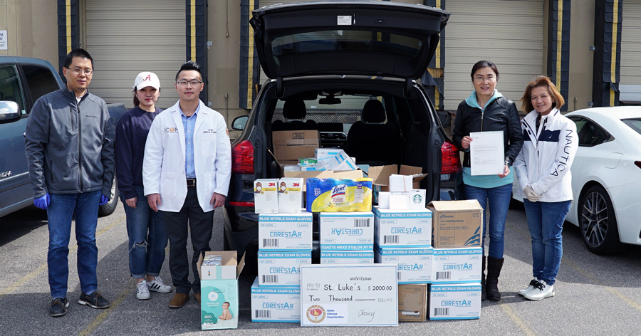ICOM Donates to St. Lukes ICOM students standing beside donations to St. Luke's hospital