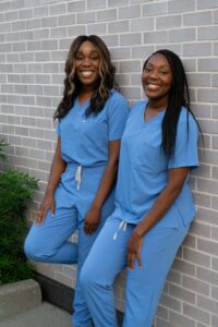 The Egwuatu sisters in blue scrubs.