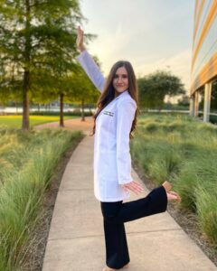 Dr. Finger posing in her white coat.