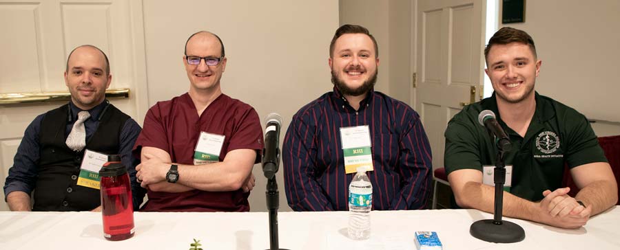 cr_WVSOM-3.26.20-3-of-3 Four panelists sit at a table behind their microphones.