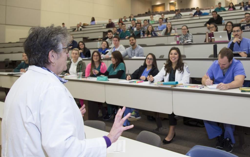 Post-Bacc premed class Medical Professor teaching students in a full lecture hall