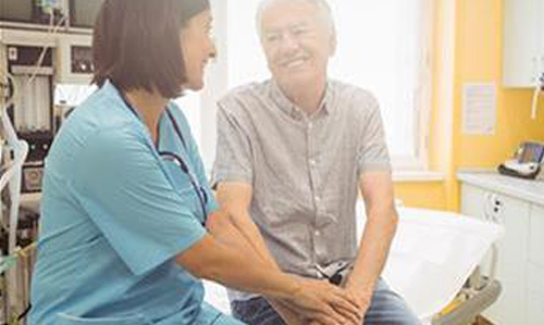 Physician comforting elderly patient