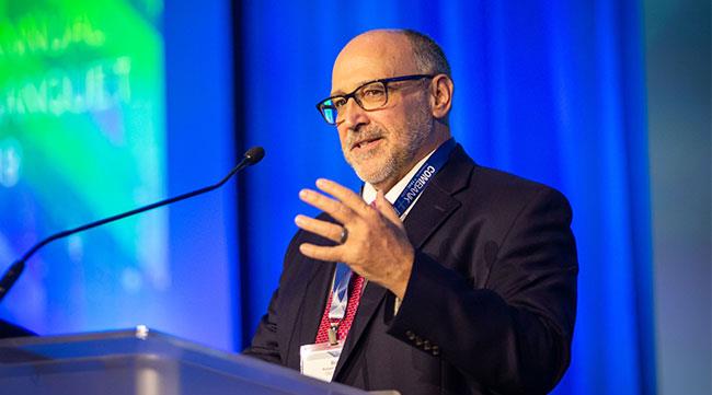 Dr. Cain speaking from a podium.